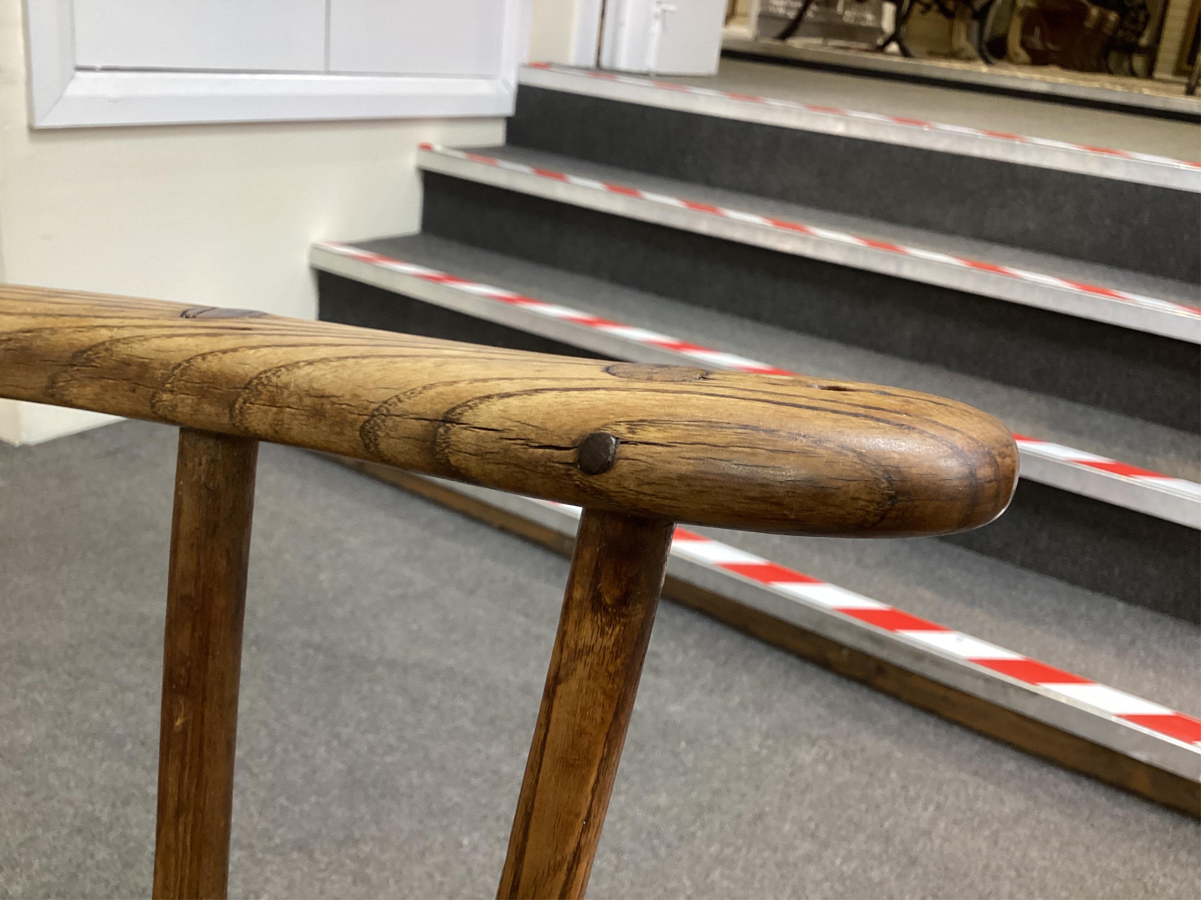 An 18th or 19th century primitive ash and elm Windsor armchair